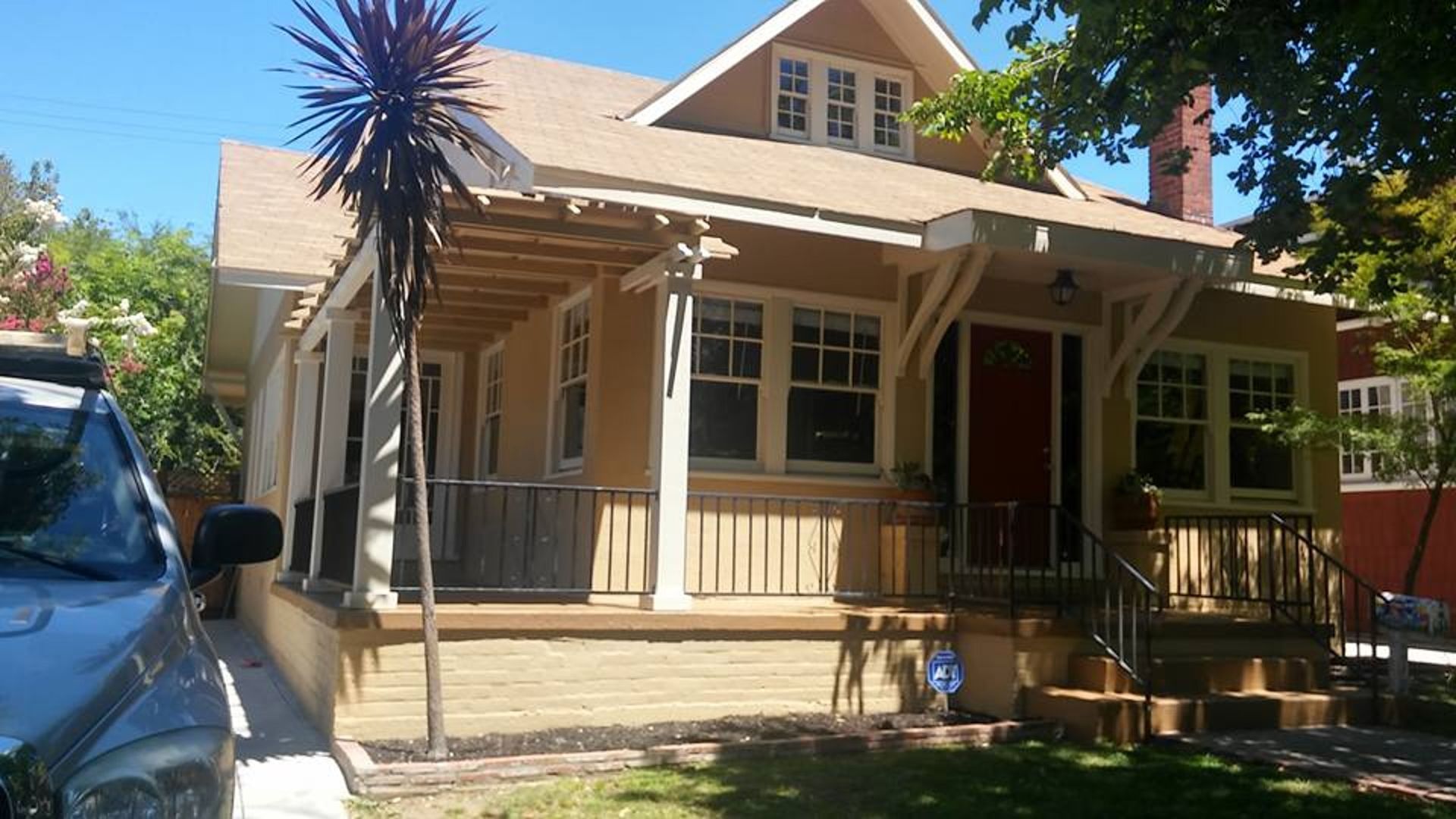 A house with a car parked in front of it
