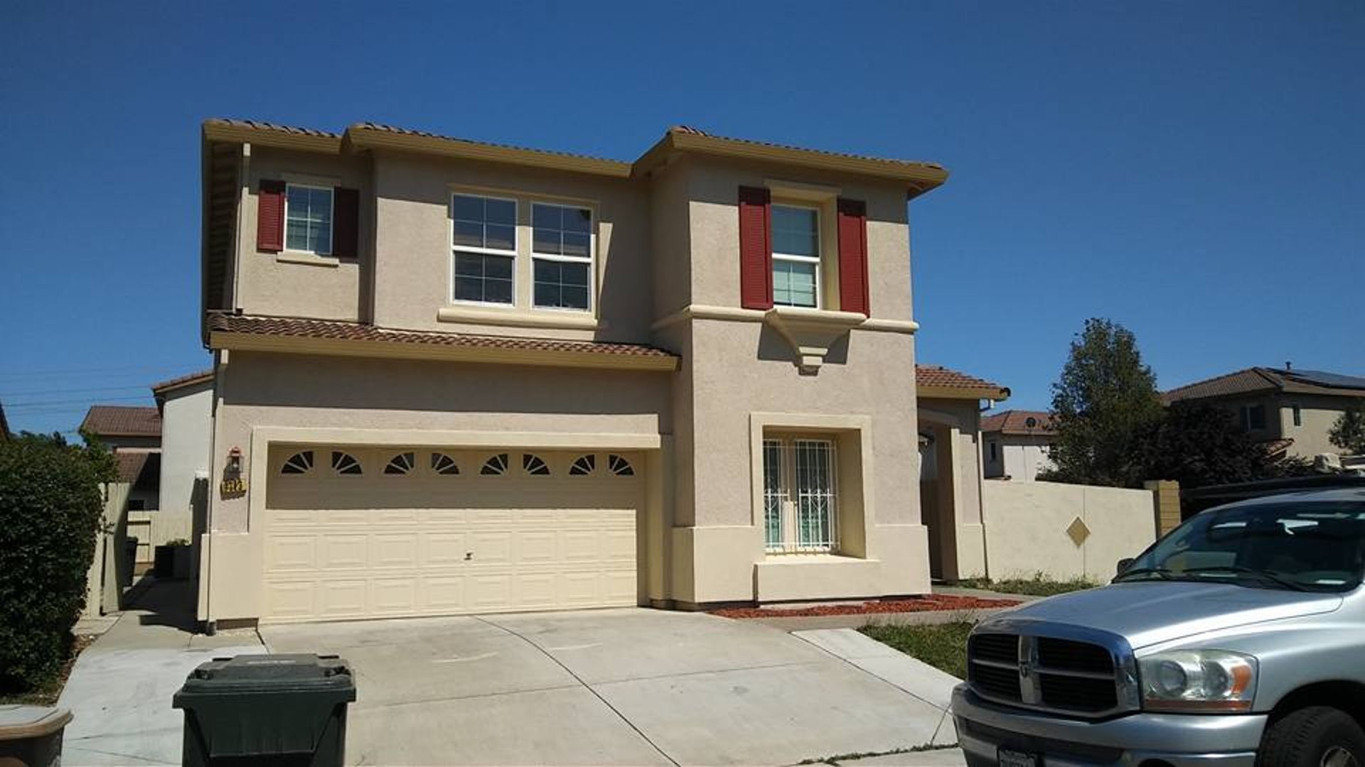A dodge ram truck is parked in front of a house