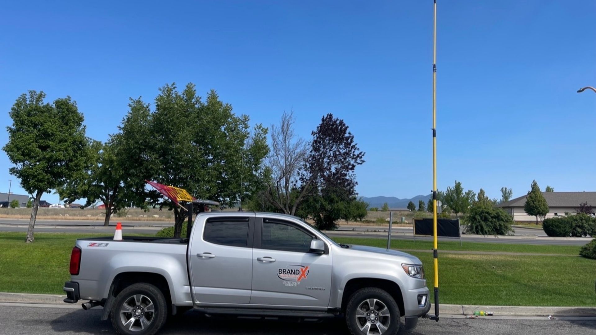 Interior of a car with a white steering wheel, black door panel, and light-colored dashboard.