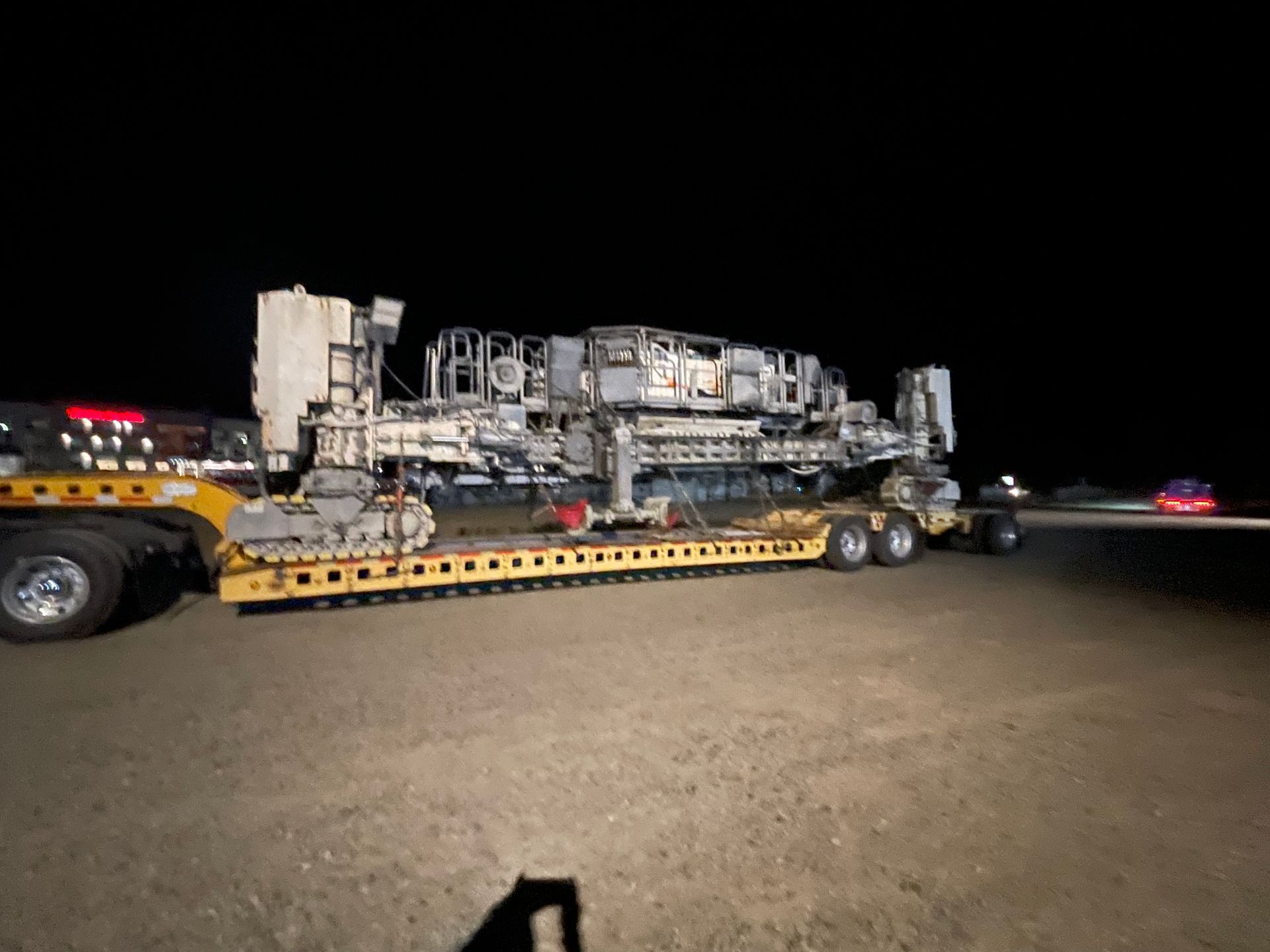 Nighttime heavy haul escort service with oversized industrial equipment transport