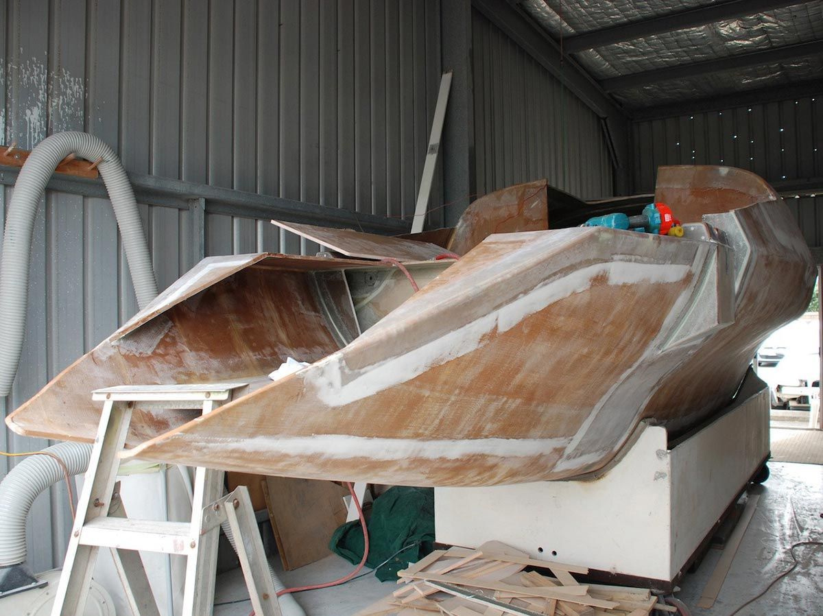 A Boat Is Being Built Inside of A Building — Ashby Boat Builders In Buddina, QLD