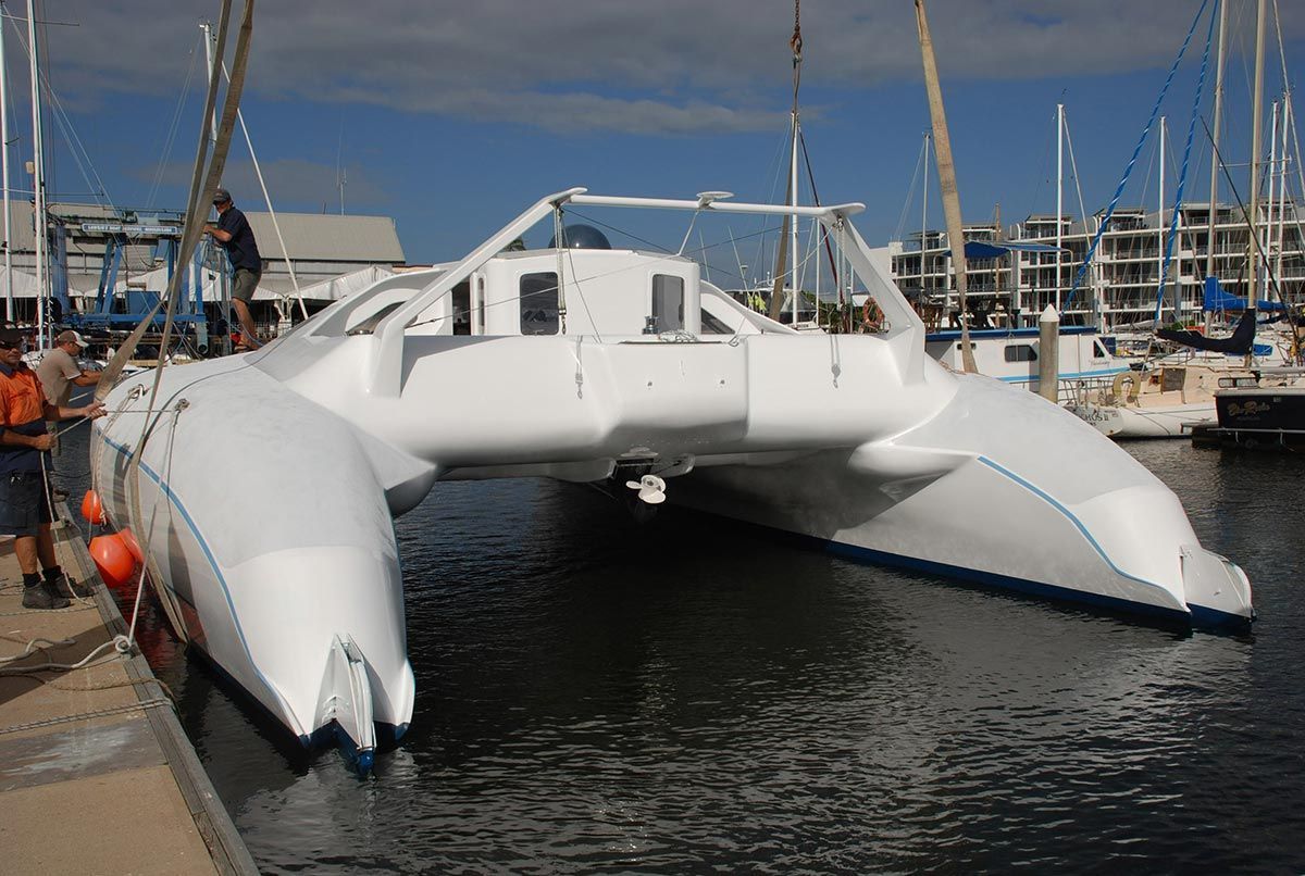 A Large White Boat Is Docked in A Marina — Ashby Boat Builders In Buddina, QLD