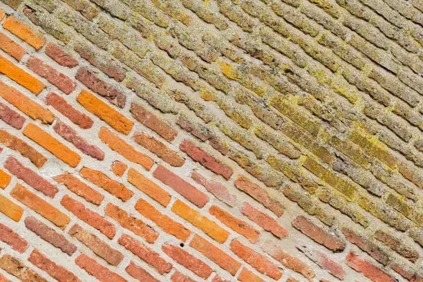 A close up of a brick wall with a diagonal pattern.