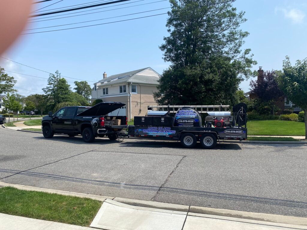 A truck with the hood up is pulling a trailer