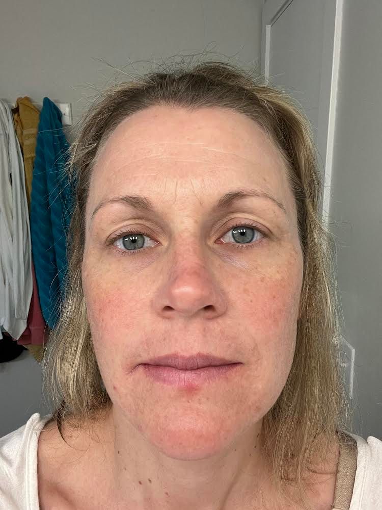 Woman with fair skin, light eyes, and blonde hair, looking directly at the camera.