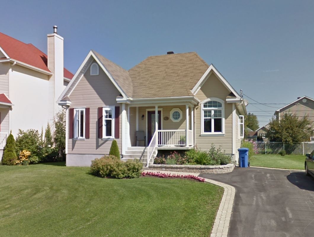 Une maison avec beaucoup de fenêtres et une allée