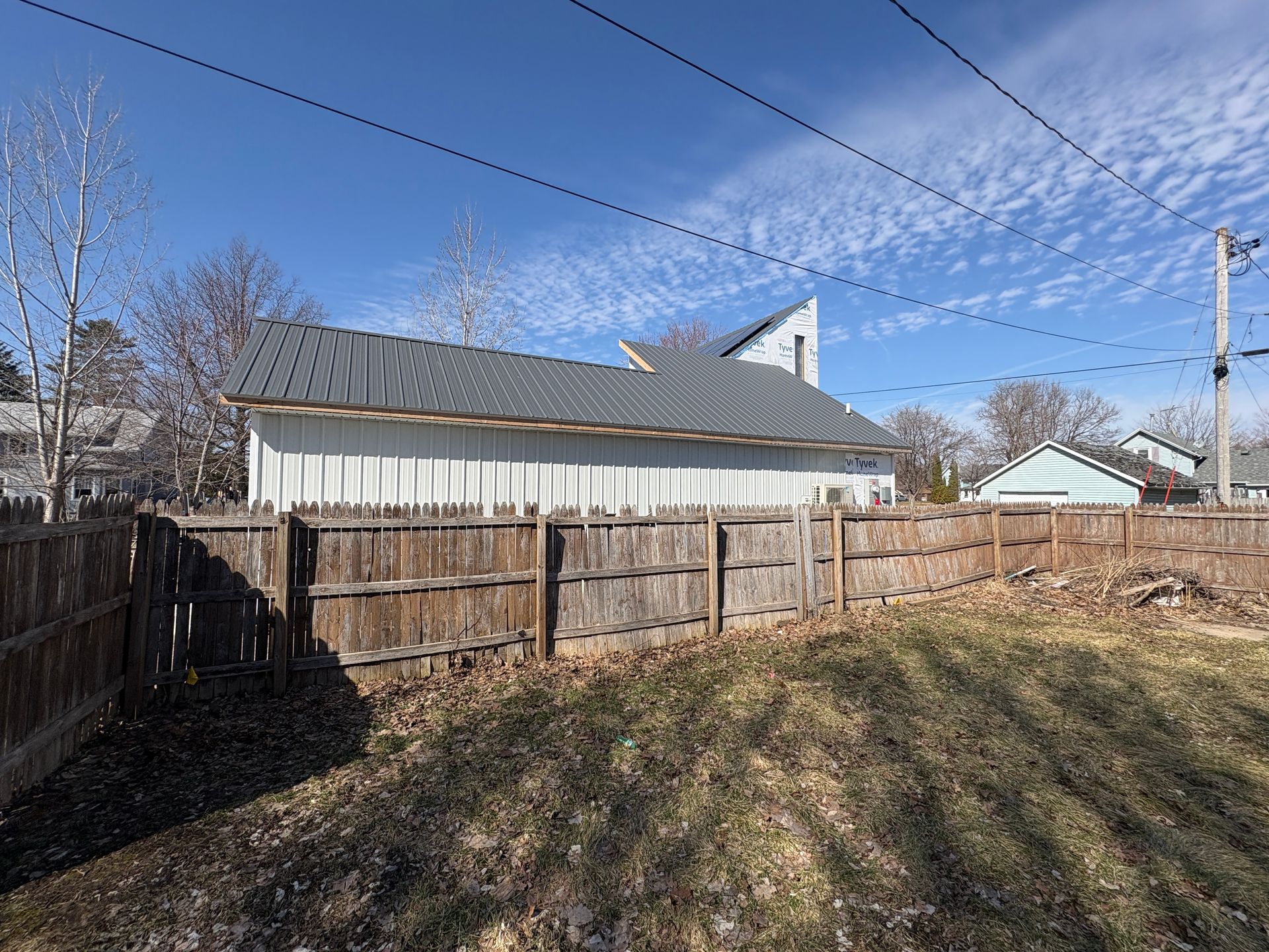 New grey metal roof installation for a remodeling project in Lansing, Iowa.