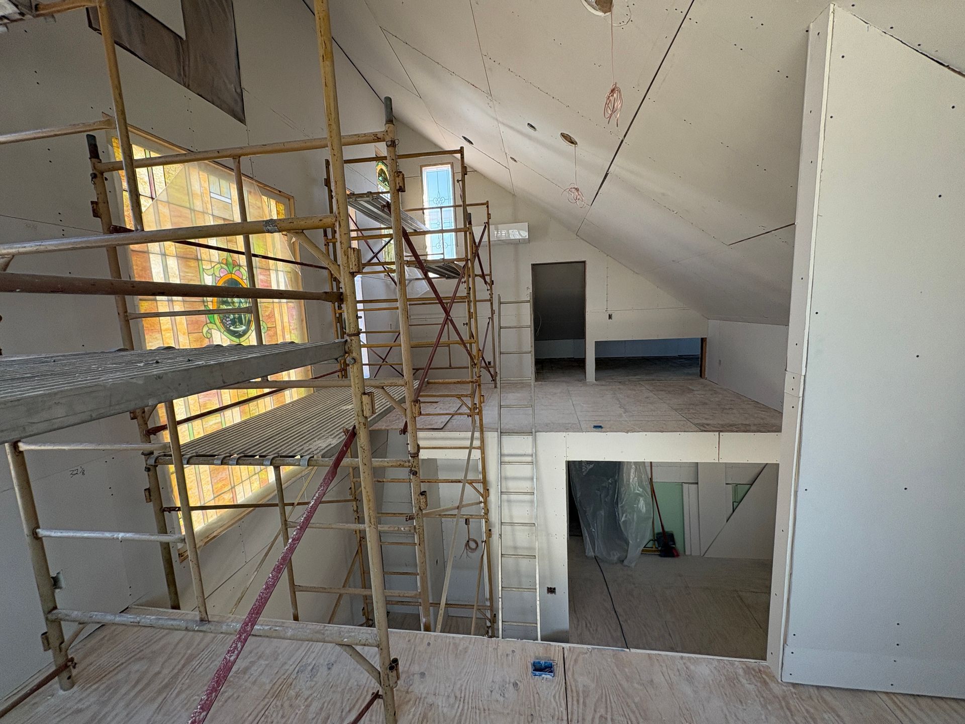 Building a vaulted ceiling home addition with scaffolding in Lansing, Iowa.