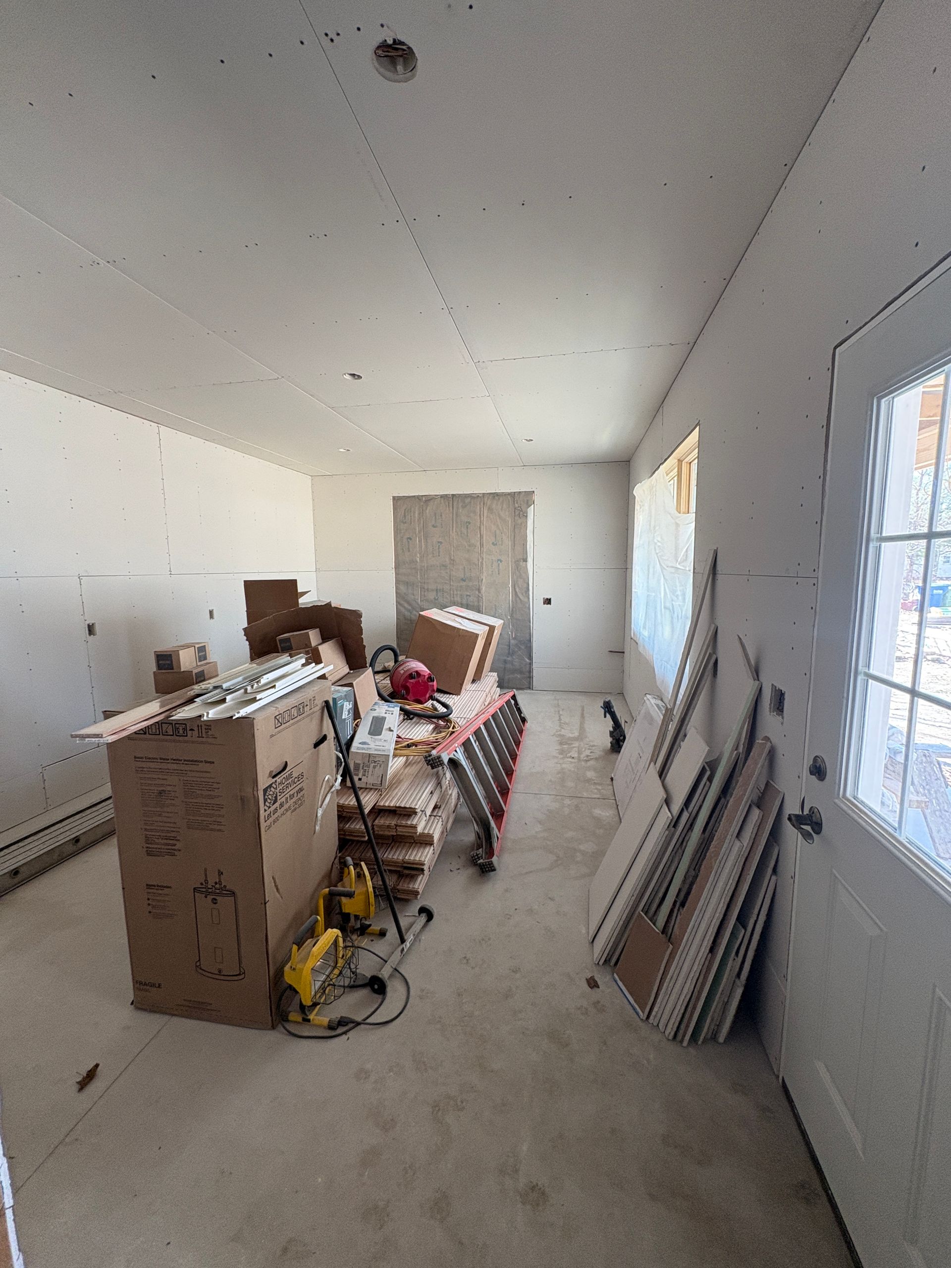 Staging tongue-and-groove wood ceiling planks for a remodeling project in Lansing, Iowa.