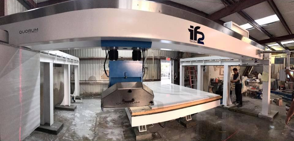 CNC machine cutting a circular pattern into a light-colored material; close-up view.