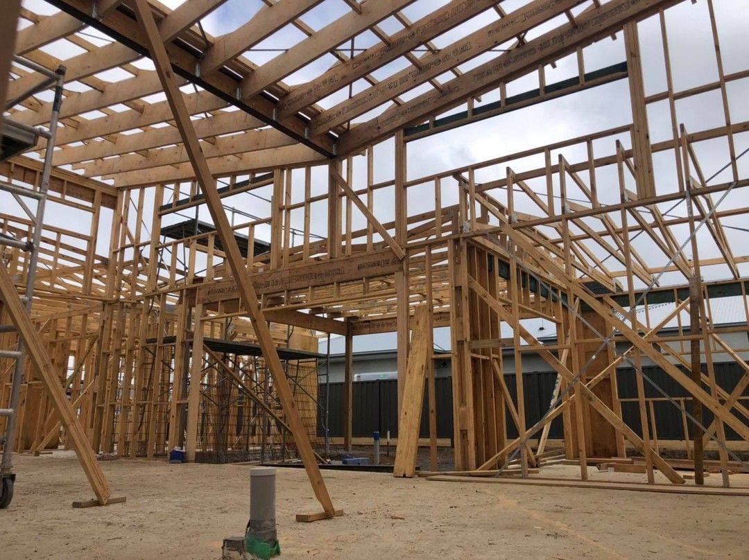 A Large Wooden Structure is Being Built on a Dirt Field — Evoke Building Group In Ballarat Central, VIC