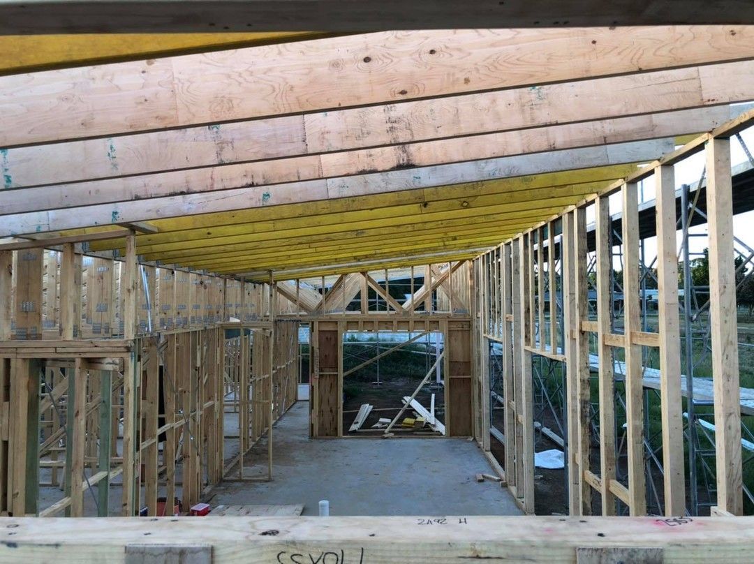 A House is Being Built With Wooden Beams and Scaffolding — Evoke Building Group In Ballarat Central, VIC