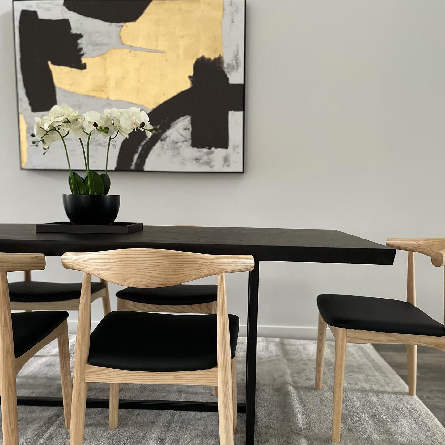 Black and Gold Painting Hangs above a Dining Table — Home Construction in Ballan, VIC