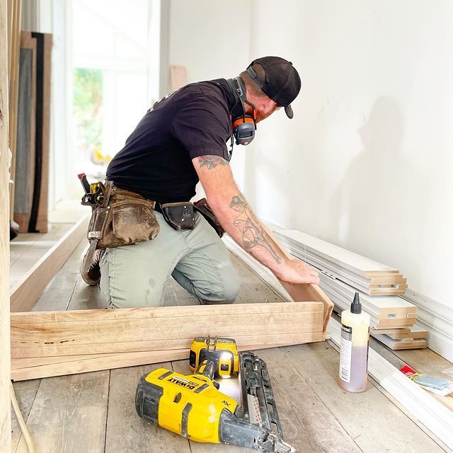 A Man Wearing a Gas Mask is Kneeling Down in a Room — Evoke Building Group In Ballarat Central, VIC