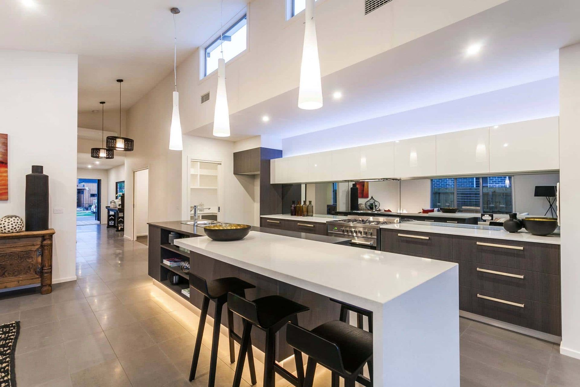 Kitchen with White Cabinets and Black Stools — Home Construction in Geelong, VIC