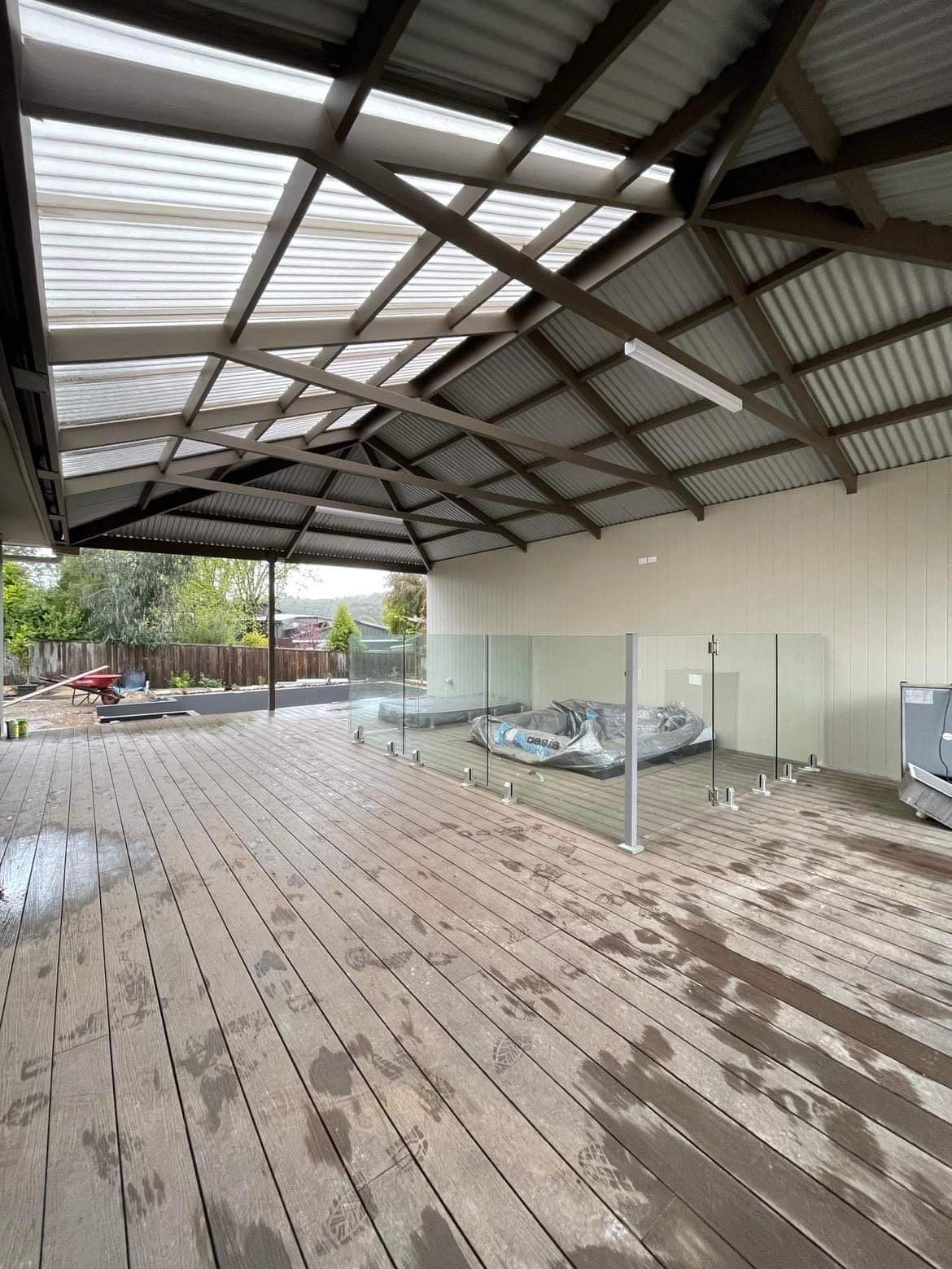 A Large Empty Room With a Wooden Floor and a Roof — Evoke Building Group In Ballarat Central, VIC