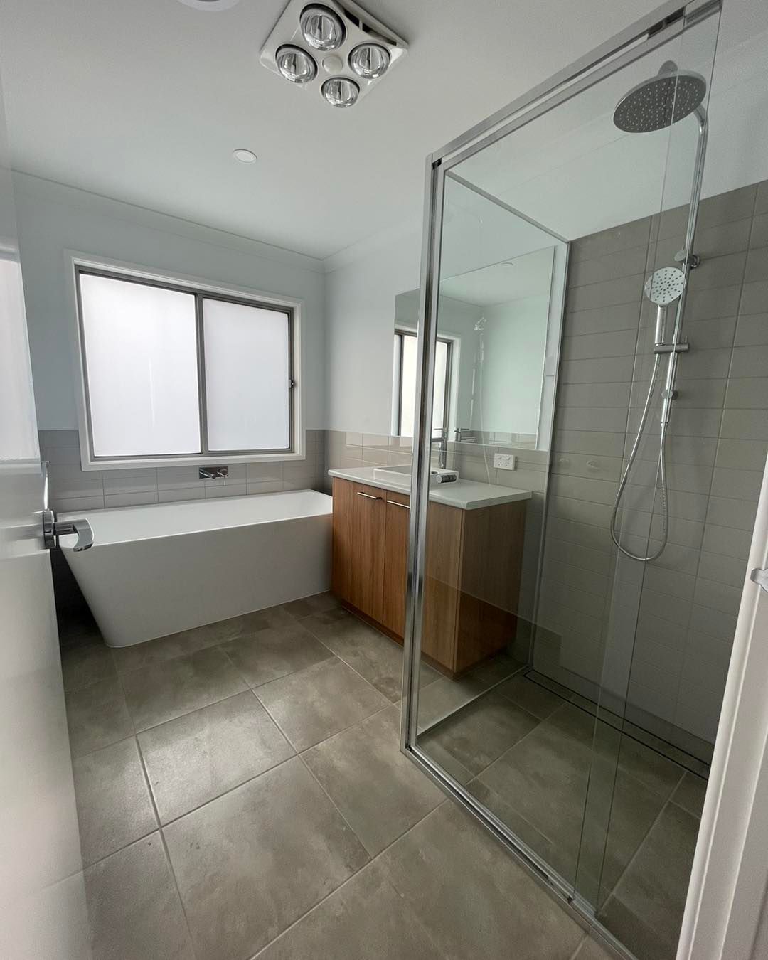 A Brown and White Dog is Standing on a Wooden Deck — Evoke Building Group In Ballarat Central, VIC