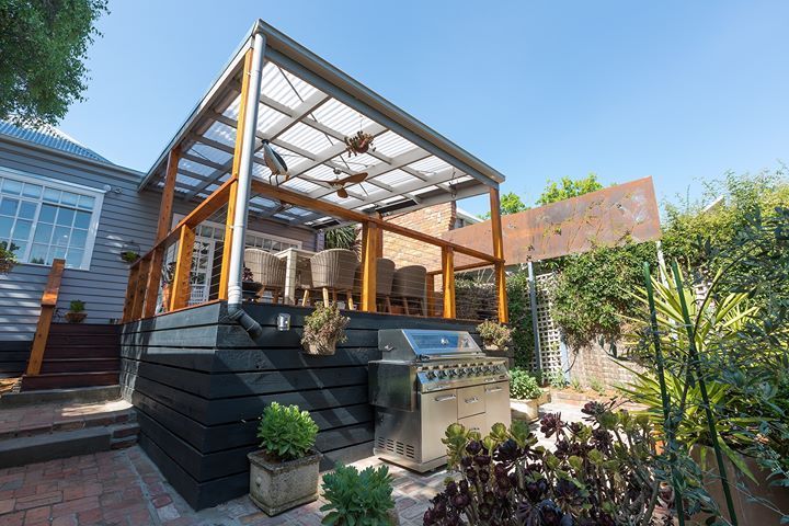 A Patio With a Grill and a Pergola in the Backyard of a House — Evoke Building Group In Ballarat Central, VIC