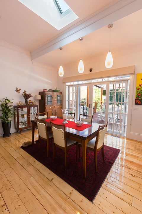 A Dining Room With a Table and Chairs and a Skylight — Evoke Building Group In Ballarat Central, VIC