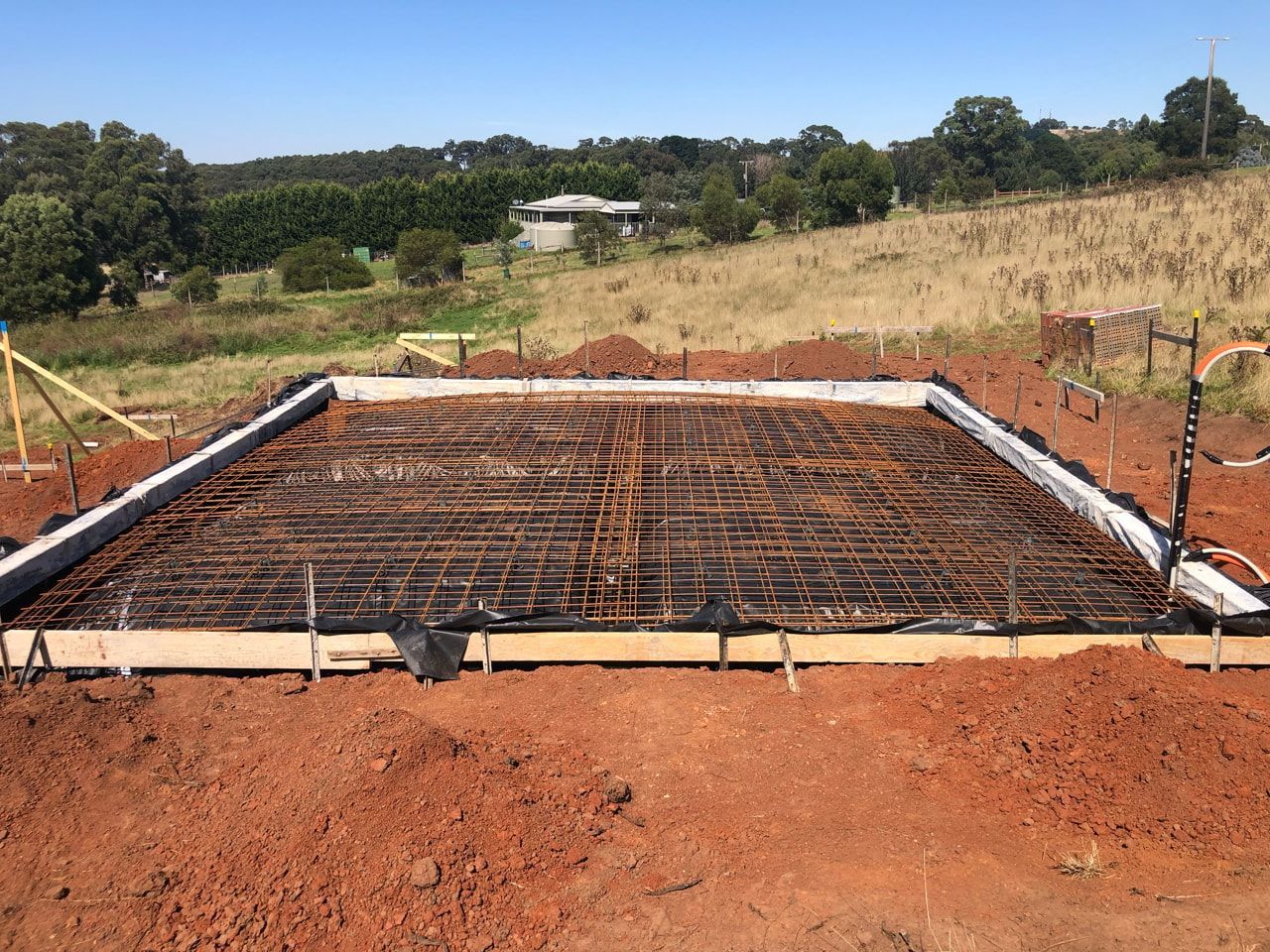 A Kitchen With Wooden Cabinets , a Washer and Dryer , and a Sink — Evoke Building Group In Ballarat Central, VIC