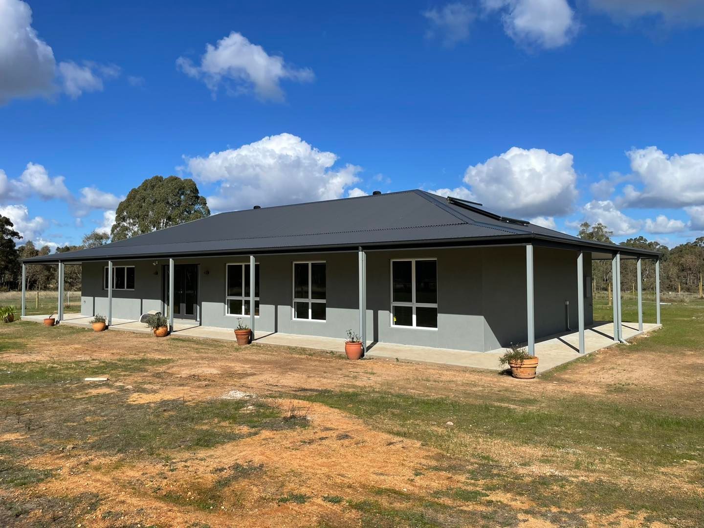 A Large House With a Porch in the Middle of a Field — Evoke Building Group In Ballarat Central, VIC