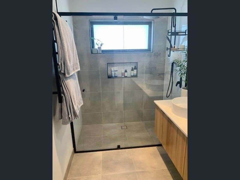 A Bathroom With a Walk in Shower and a Sink — Evoke Building Group In Ballarat Central, VIC