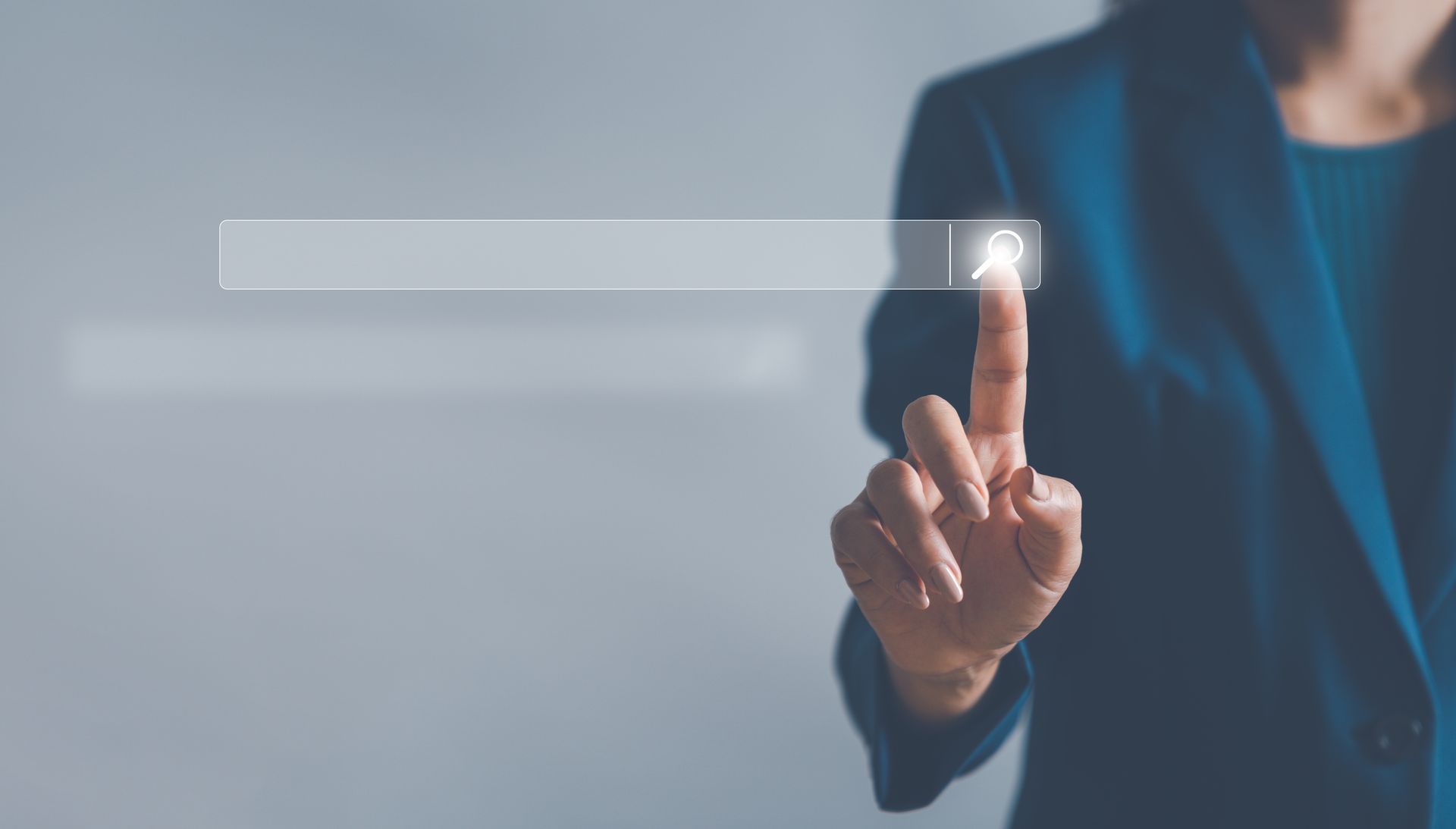 A woman is smiling with her eyes closed and her hair blowing in the wind.