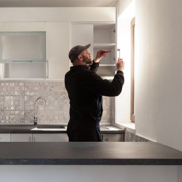 Carpenter working on new kitchen.