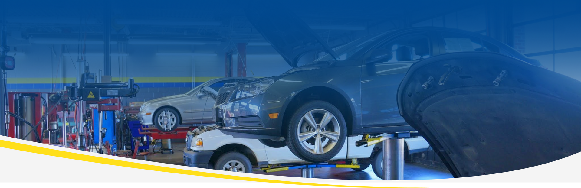A car is sitting on a lift in a garage | D.W. Campbell Tire & Service