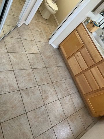 A bathroom with a sink , toilet and mirror.