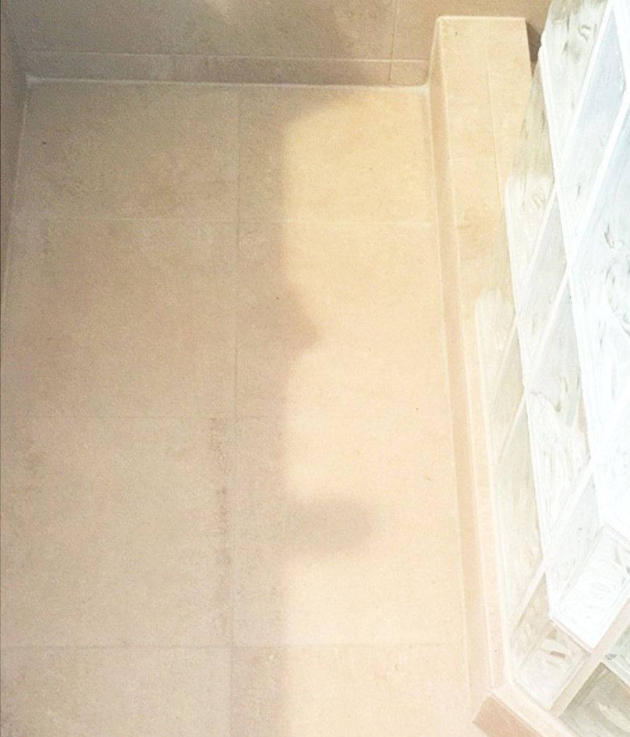 There is a shadow of a person on the floor of a room.