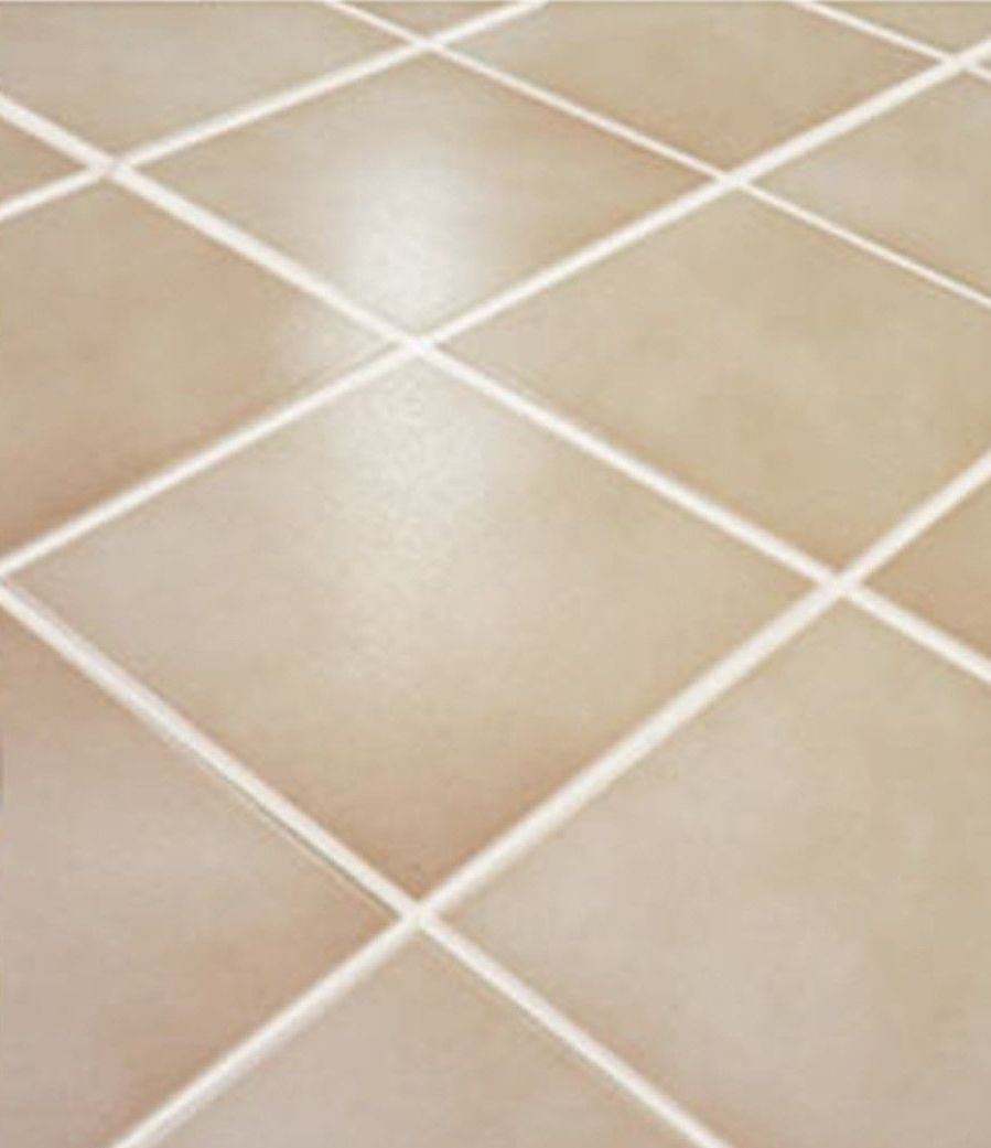 A close up of a tiled floor with white grout.