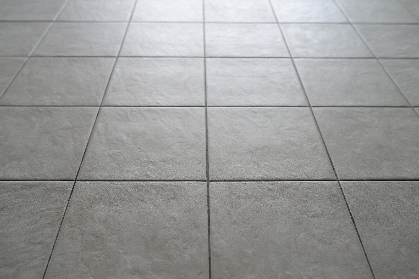 A close up of a tiled floor in a room.