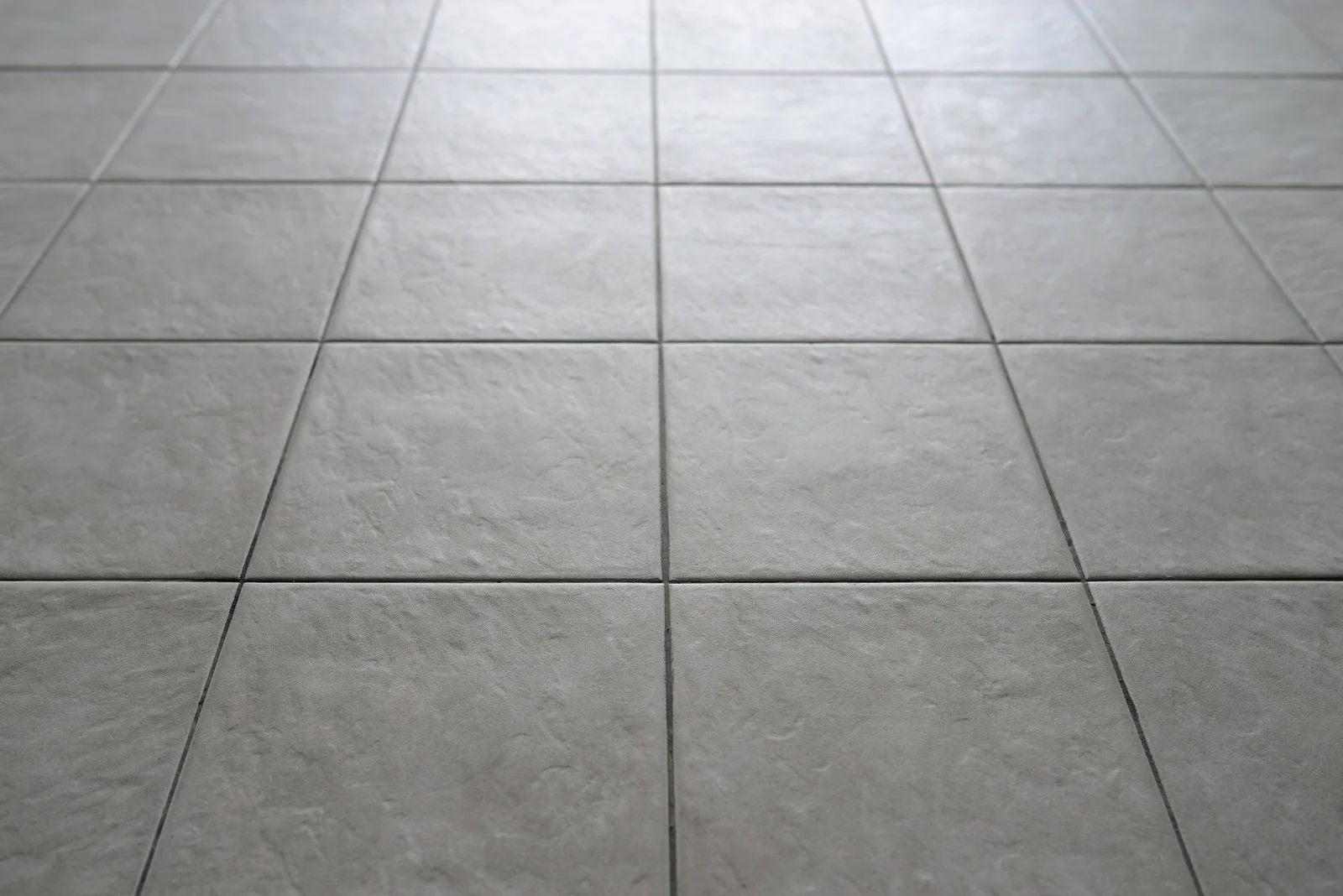 Gray tiled floor, perspective view.