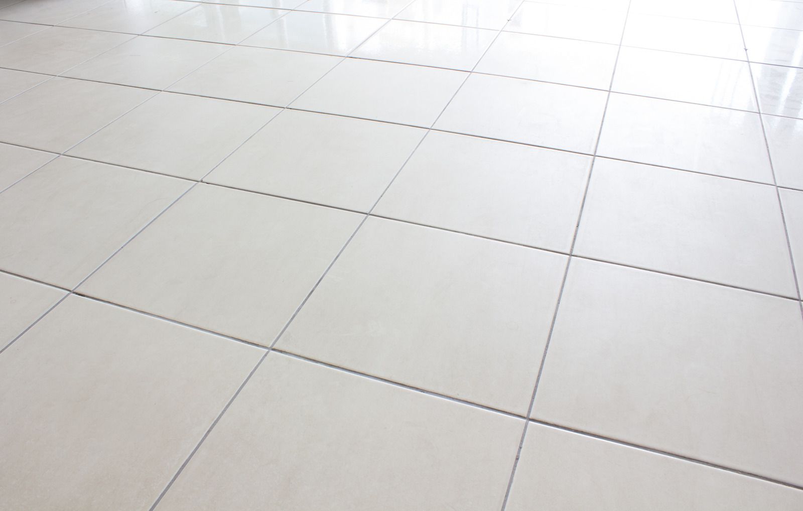 White tiled floor with dark grout.