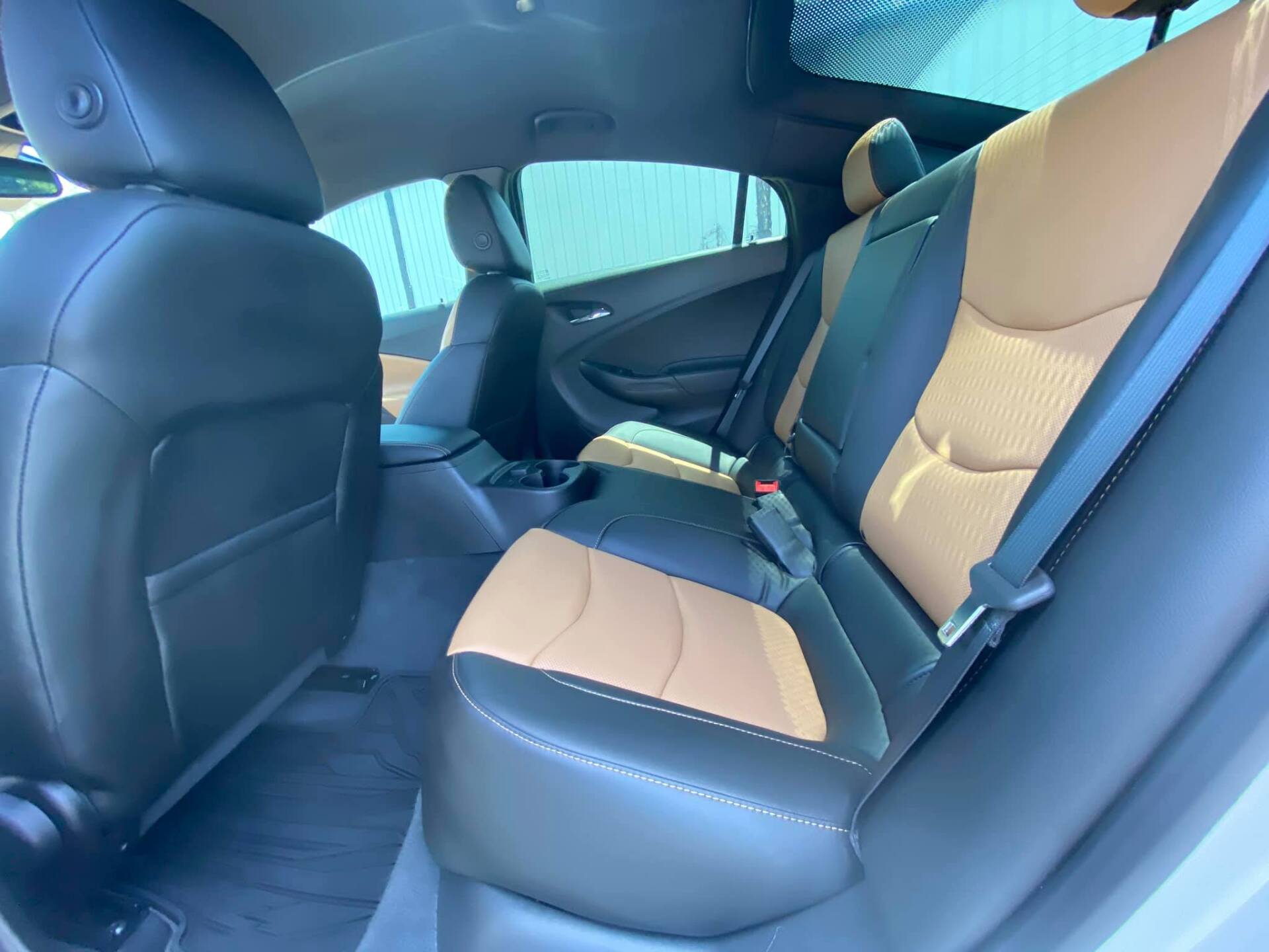 Interior back seats of a car; black and tan leather seats.