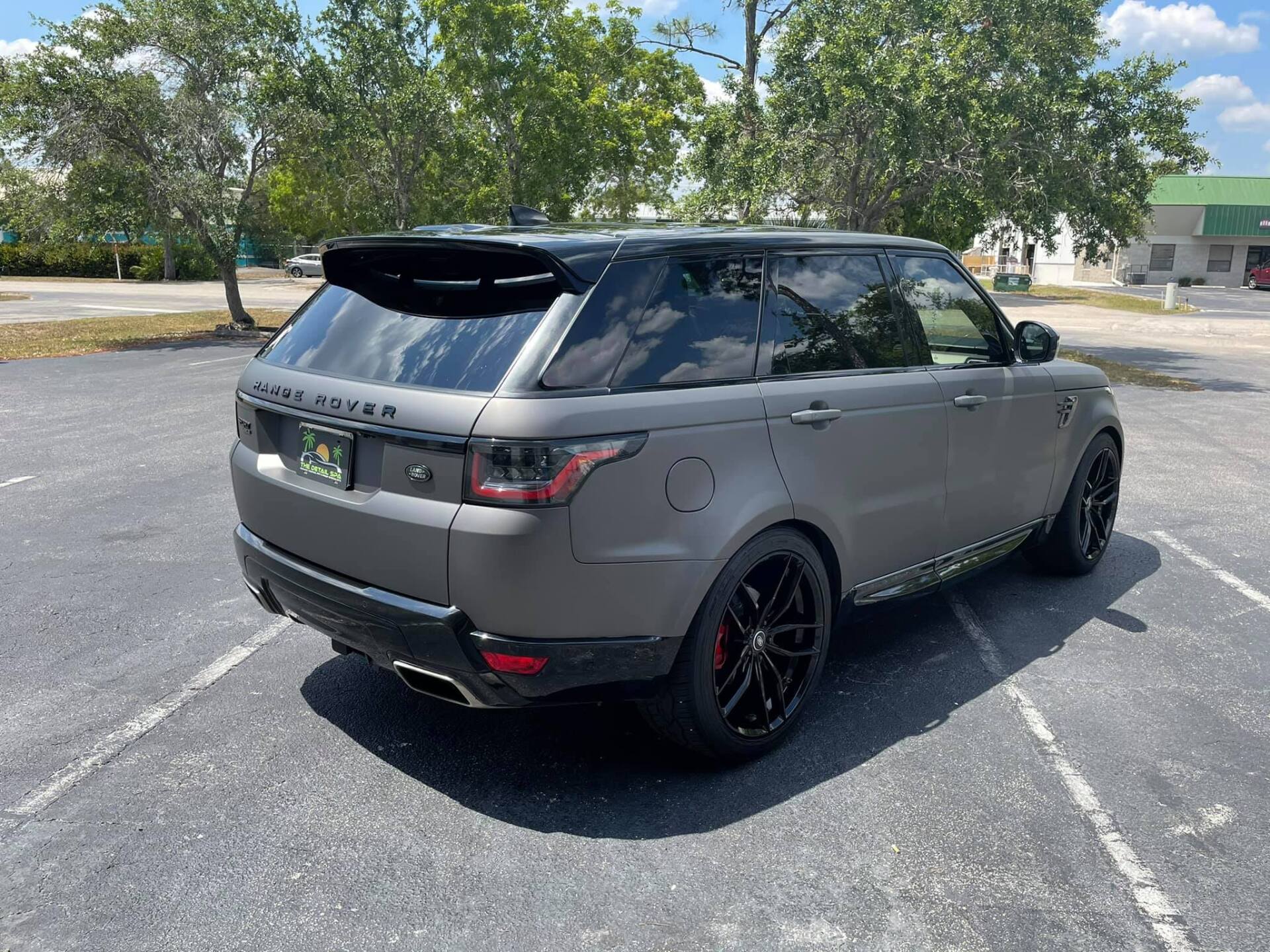 Gray Range Rover SUV with black accents parked on asphalt.