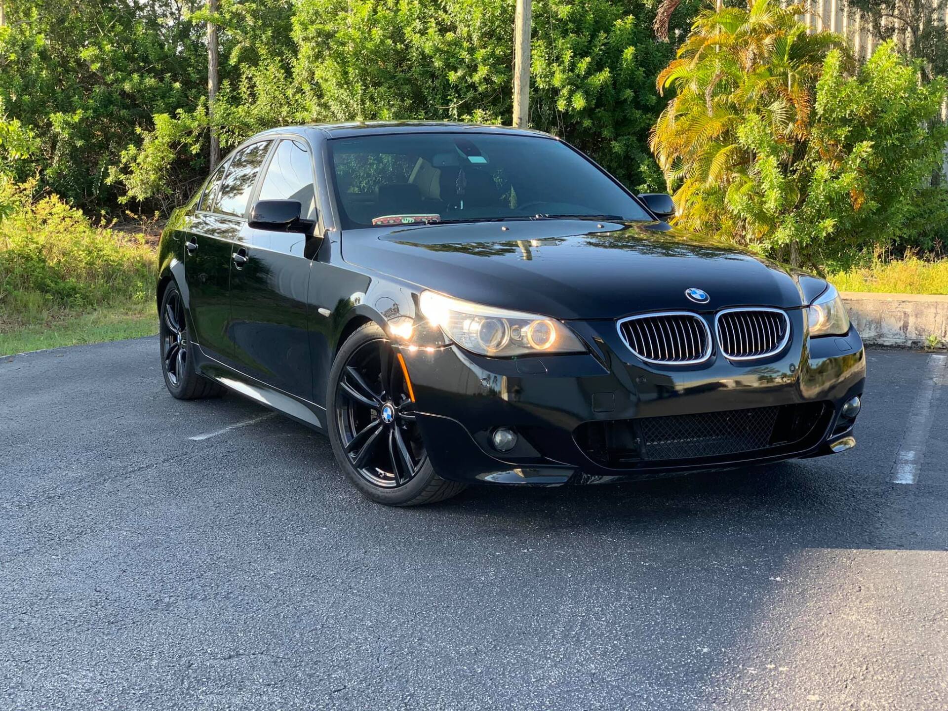 Black BMW sedan parked on asphalt.
