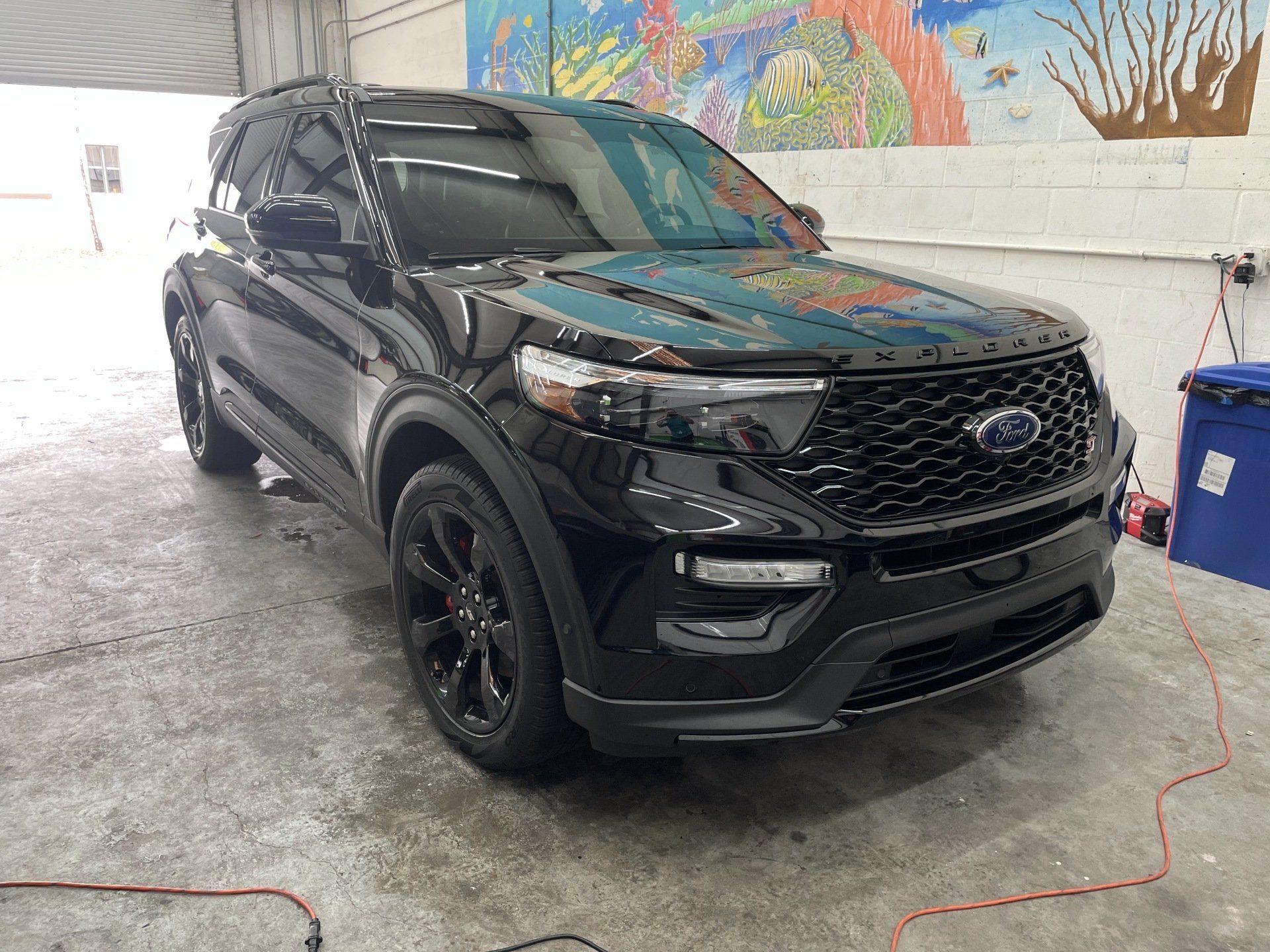 Black Ford Explorer SUV parked inside a building.