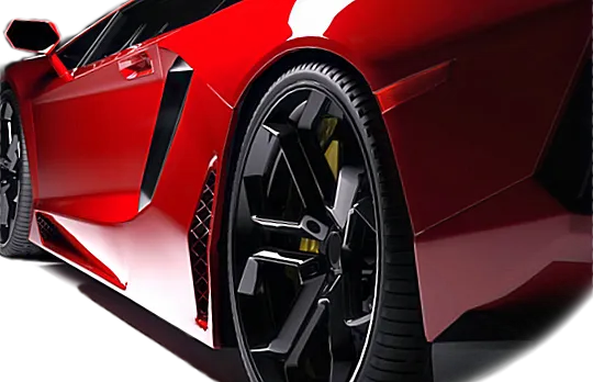 Red sports car's rear quarter, black wheels, and aerodynamic design against a white background.