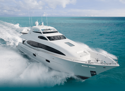 White yacht speeding through turquoise ocean.