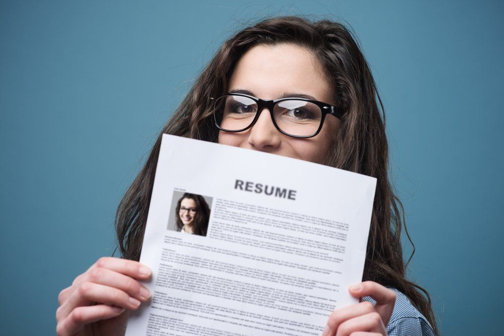 Woman Holding Her Resume — Academic & Music Tutors in Newcastle NSW
