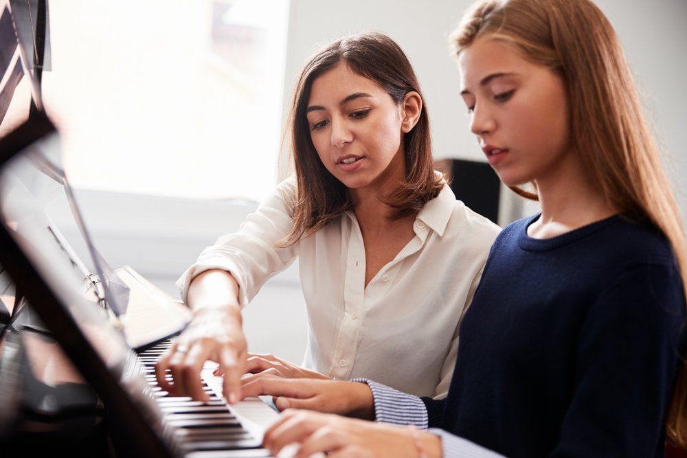 Teacher & Student During Piano Lesson — Academic & Music Tutors in Newcastle NSW
