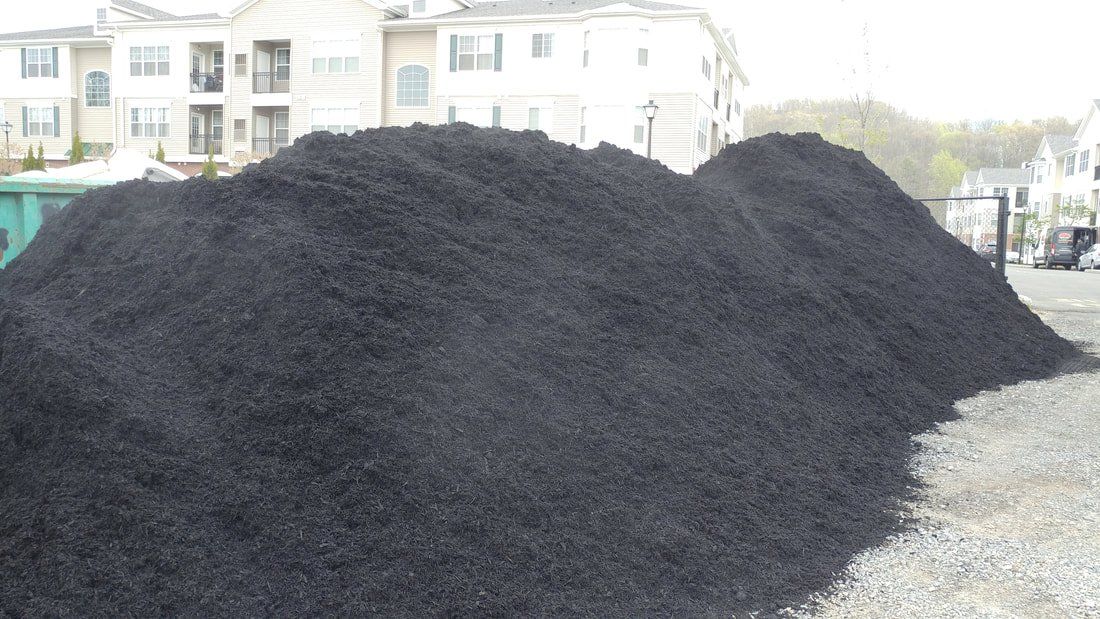 Black Dyed Mulch Piled on Construction Site — Monroe Township, NJ — Slammin Canz, Inc.