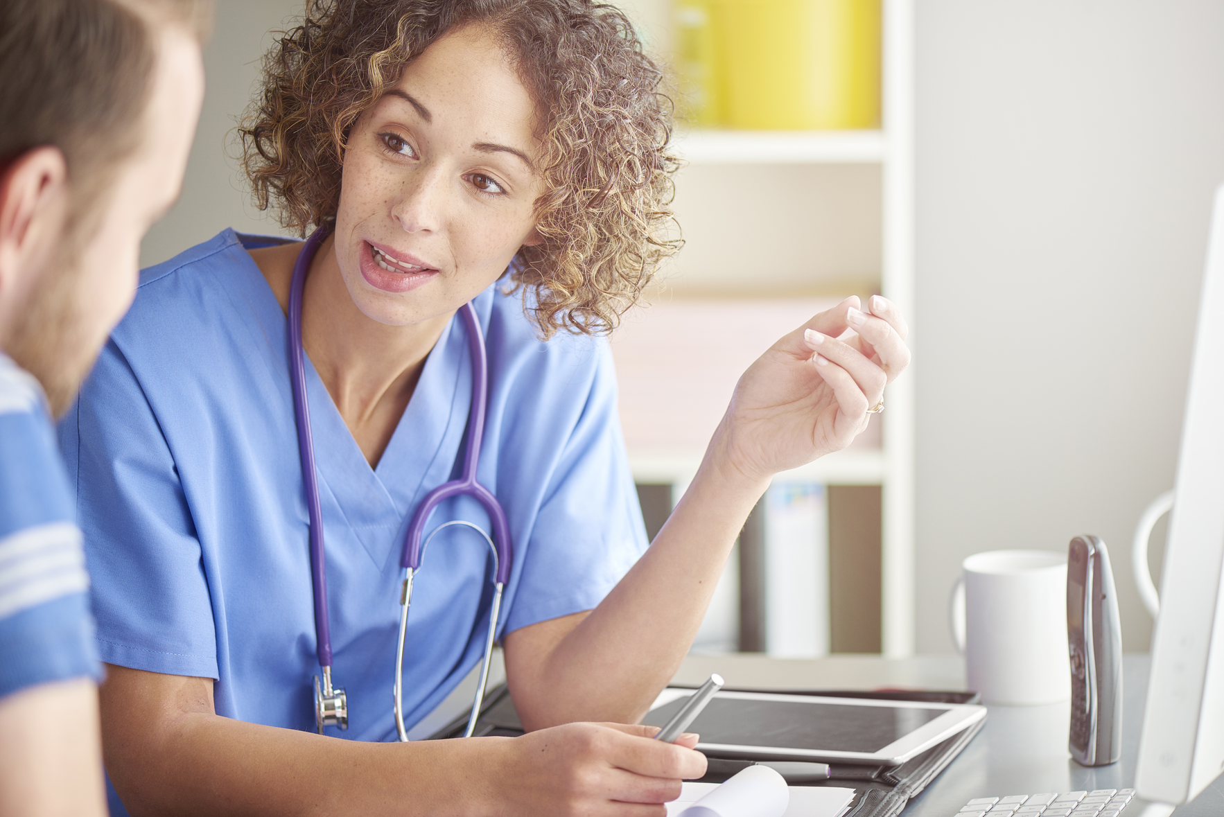 Physical Therapist Wearing Stethoscope Talking to Patient