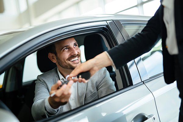 Professional Woman Salesperson with Customer at Car Dealership — Chicago, IL — Illinois Insurance Center Inc