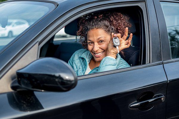 Woman Smiling Showing New Car Keys and Car — Chicago, IL — Illinois Insurance Center Inc