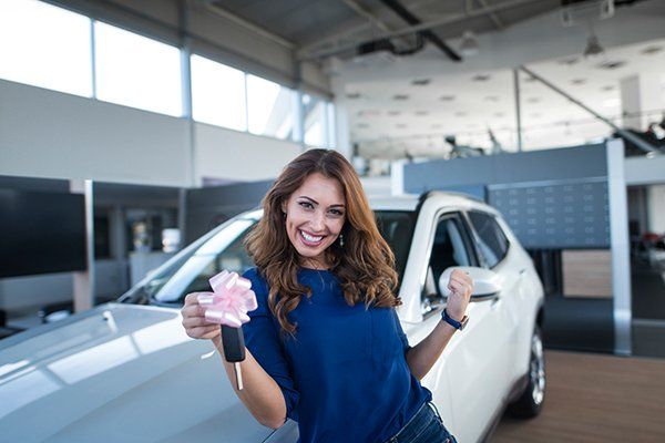 Woman Holding Car Keys in Front of New Vehicle — Chicago, IL — Illinois Insurance Center Inc