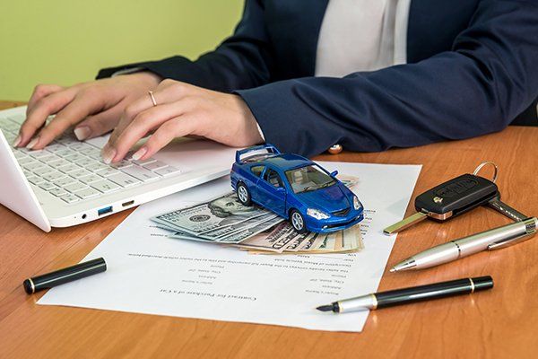 Male's Hands Signing on Car Contract Claim Form — Chicago, IL — Illinois Insurance Center Inc