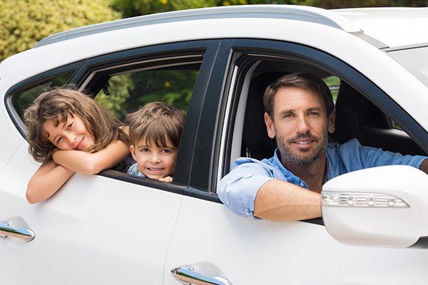 Man in Car with Children — Chicago, IL — Illinois Insurance Center Inc